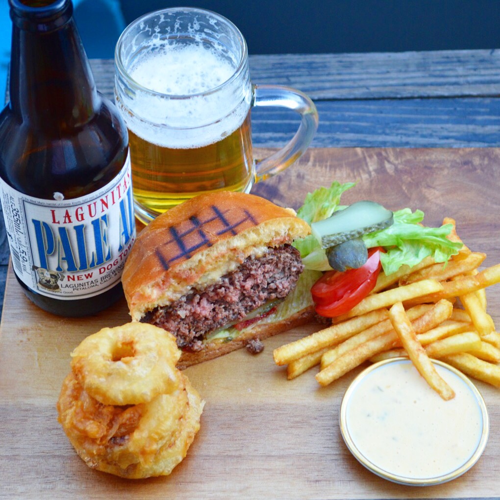 Cheeseburger with onion rings, fries, Lagunitas Pale Ale and burger sauce